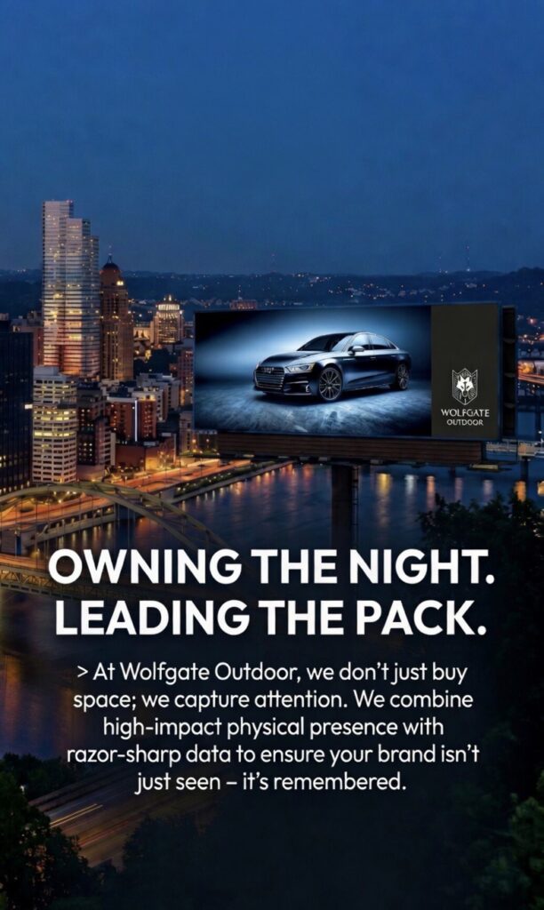 Nighttime cityscape with a brightly lit car billboard from Wolfgate Outdoor.